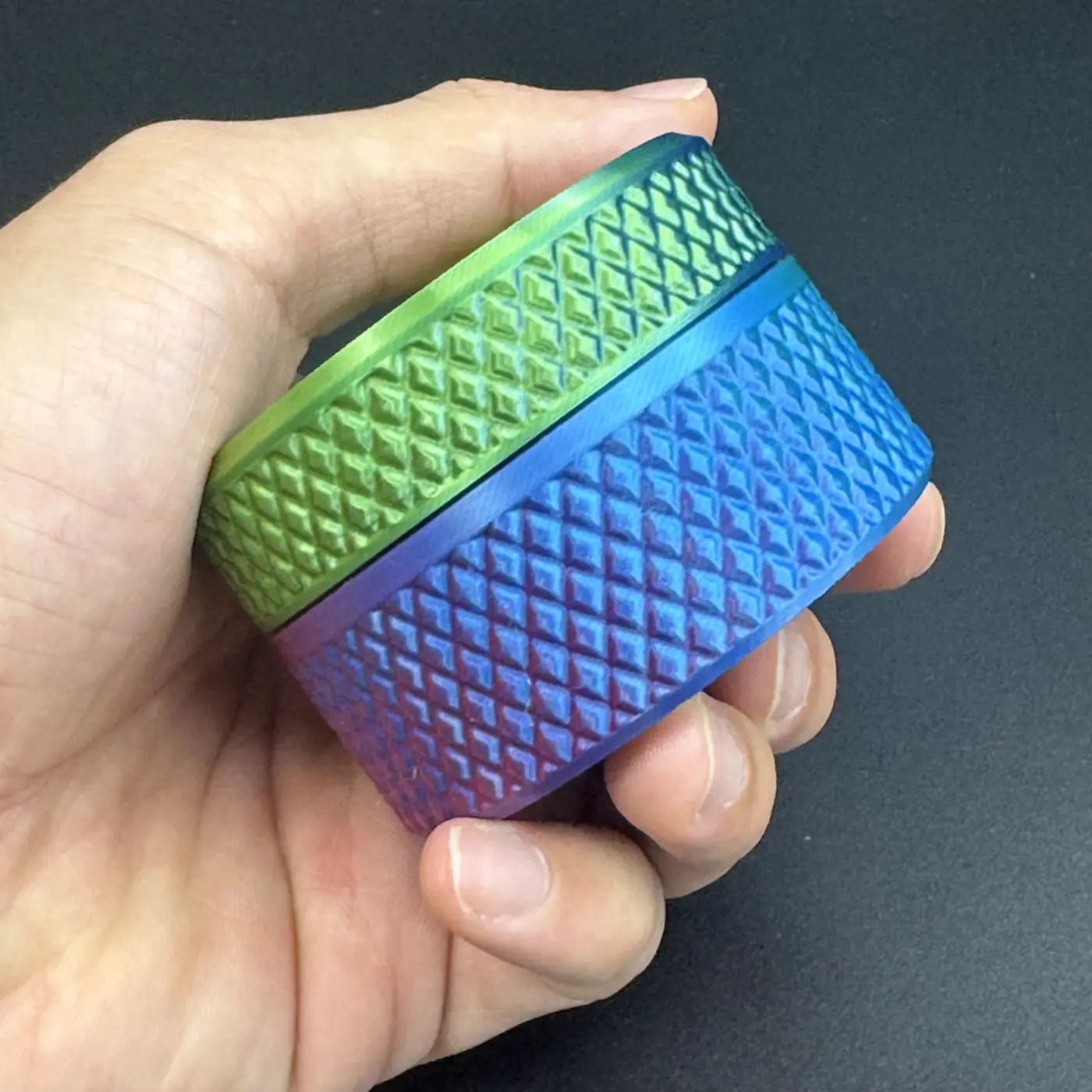 hand holding the closed cylindrical vial case for scale